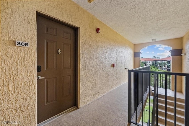 12980 Positano Cir Unit 306, Naples, FL 34105 - entrance to property with stucco siding and a balcony