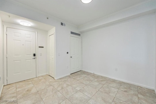 12980 Positano Cir Unit 306, Naples, FL 34105 - foyer entrance with light tile patterned flooring and baseboards