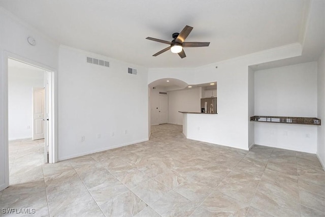 12980 Positano Cir Unit 306, Naples, FL 34105 - unfurnished living room featuring arched walkways, ceiling fan, and crown molding