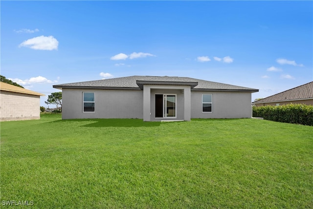 1101 NW 21st St, Cape Coral, FL 33993 - back of house featuring stucco siding, a lawn, and a shingled roof