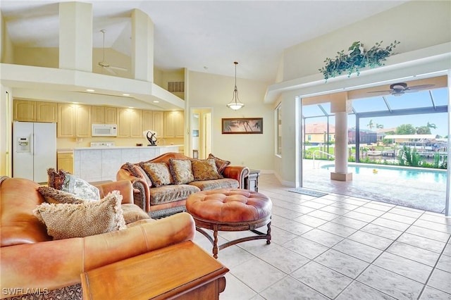 3206 SW 4th Ln, Cape Coral, FL 33991 - living room featuring a ceiling fan, light tile patterned floors, and high vaulted ceiling