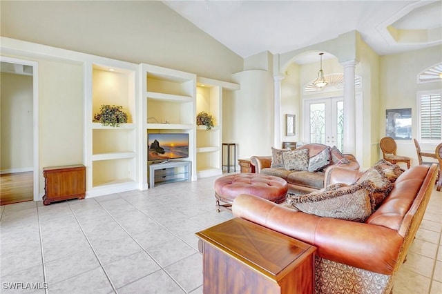 3206 SW 4th Ln, Cape Coral, FL 33991 - living room with decorative columns, arched walkways, built in shelves, light tile patterned floors, and french doors