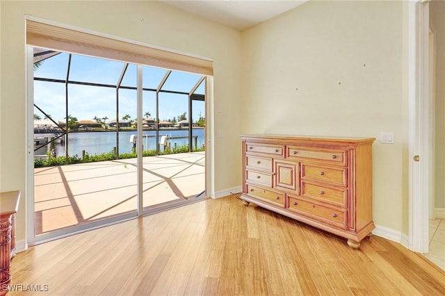 3206 SW 4th Ln, Cape Coral, FL 33991 - bedroom with light wood-style flooring, a water view, and access to outside