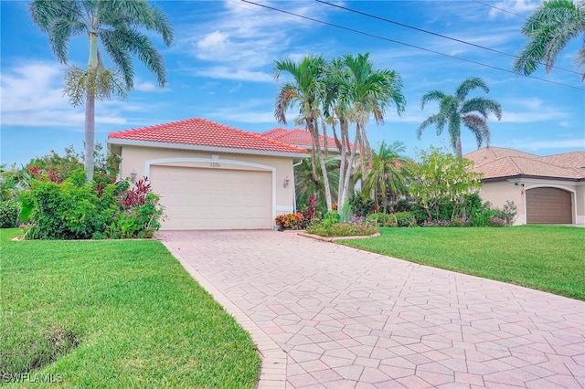 3206 SW 4th Ln, Cape Coral, FL 33991 - mediterranean / spanish-style home featuring a front yard, decorative driveway, a garage, stucco siding, and a tile roof