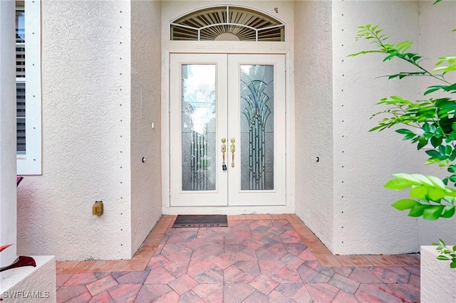 3206 SW 4th Ln, Cape Coral, FL 33991 - view of exterior entry featuring french doors and stucco siding
