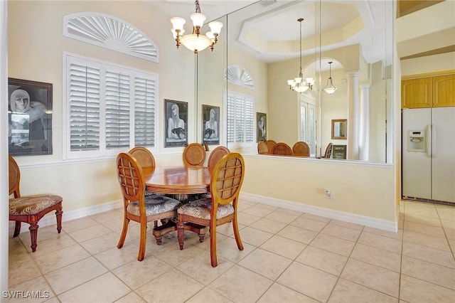 3206 SW 4th Ln, Cape Coral, FL 33991 - dining area featuring a chandelier, light tile patterned flooring, and ornate columns