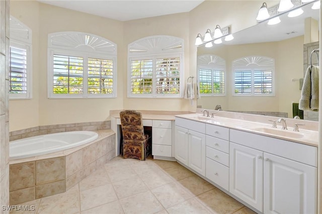 3206 SW 4th Ln, Cape Coral, FL 33991 - bathroom featuring a garden tub, double vanity, and tile patterned flooring