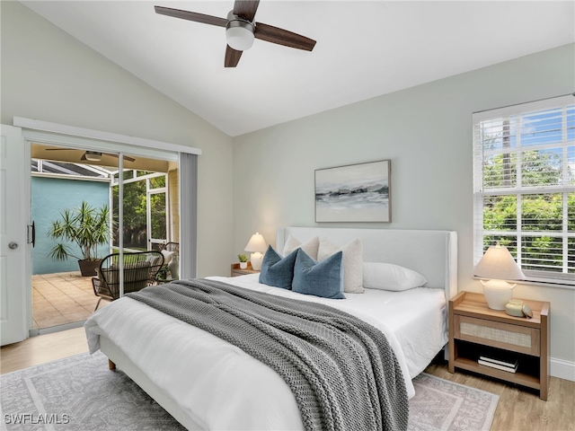 1492 La Petite Ct, Naples, FL 34104 - bedroom with multiple windows, wood finished floors, vaulted ceiling, access to outside, and ceiling fan