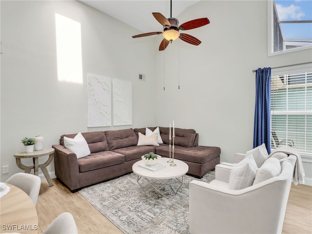 1492 La Petite Ct, Naples, FL 34104 - living room with high vaulted ceiling, light wood-type flooring, and a ceiling fan