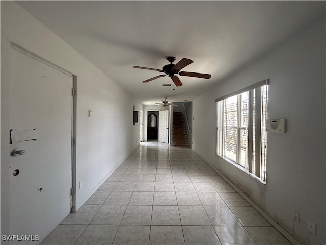 211 Oakmont Pkwy, Lehigh Acres, FL 33936 - hall featuring light tile patterned flooring and stairway