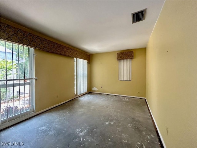 211 Oakmont Pkwy, Lehigh Acres, FL 33936 - spare room featuring plenty of natural light and unfinished concrete flooring