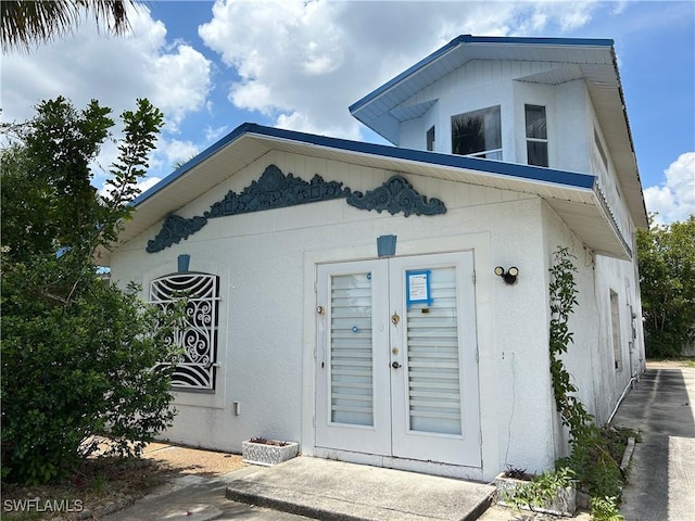 211 Oakmont Pkwy, Lehigh Acres, FL 33936 - doorway to property with french doors and stucco siding