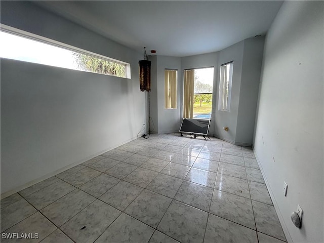 211 Oakmont Pkwy, Lehigh Acres, FL 33936 - spare room with tile patterned floors and baseboards