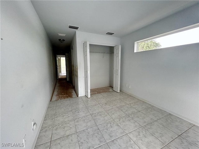 211 Oakmont Pkwy, Lehigh Acres, FL 33936 - unfurnished bedroom with a closet and light tile patterned floors