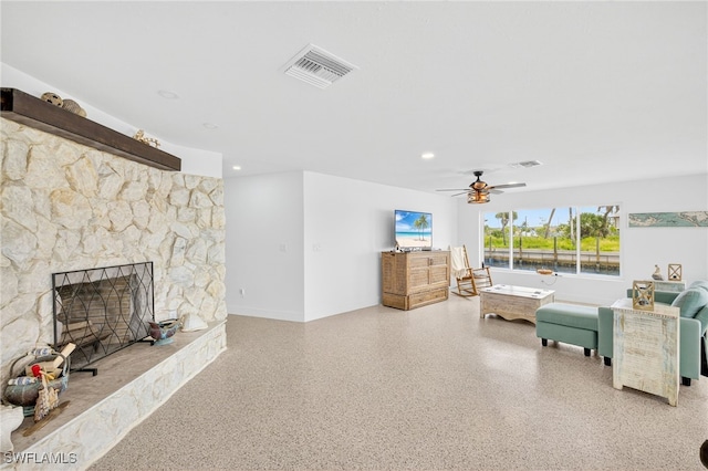 867 Oak St, Fort Myers Beach, FL 33931 - living area featuring speckled floor, a ceiling fan, and a fireplace