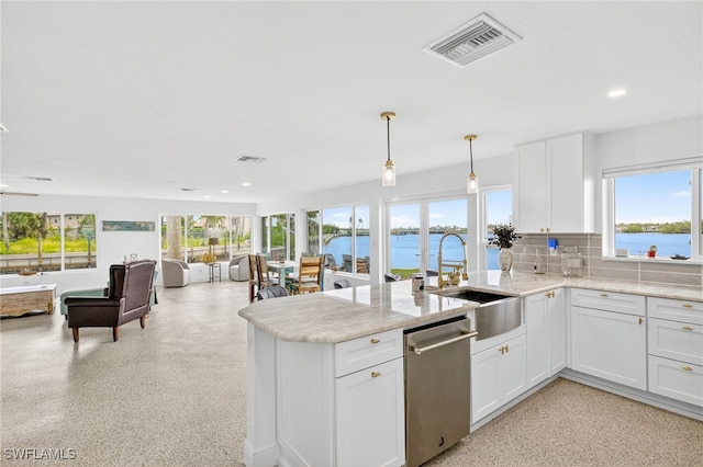 867 Oak St, Fort Myers Beach, FL 33931 - kitchen featuring stainless steel dishwasher, healthy amount of natural light, open floor plan, recessed lighting, and a peninsula