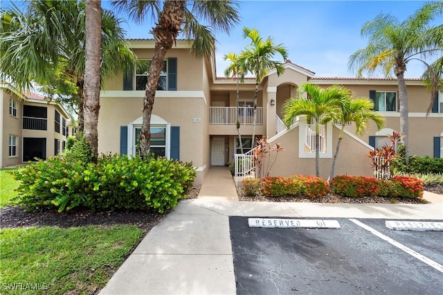 2456 Millcreek Ln Unit 201, Naples, FL 34119 - view of property with uncovered parking and stairs