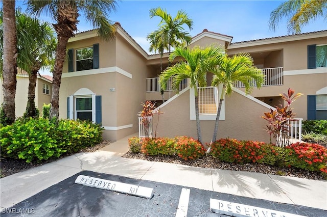 2456 Millcreek Ln Unit 201, Naples, FL 34119 - view of building exterior with uncovered parking
