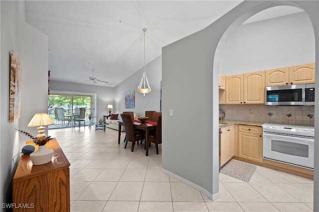 2456 Millcreek Ln Unit 201, Naples, FL 34119 - kitchen featuring stainless steel microwave, white range with electric stovetop, light brown cabinets, light tile patterned floors, and arched walkways