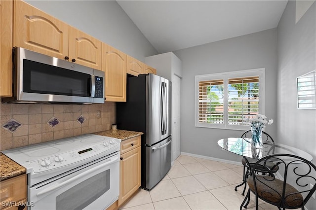 2456 Millcreek Ln Unit 201, Naples, FL 34119 - kitchen featuring stainless steel appliances, tasteful backsplash, vaulted ceiling, light stone countertops, and light brown cabinetry