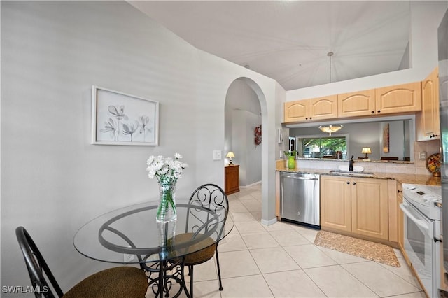2456 Millcreek Ln Unit 201, Naples, FL 34119 - kitchen with dishwasher, white range with electric stovetop, light brown cabinets, arched walkways, and light tile patterned flooring