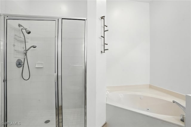 1000 L Ambiance Cir Unit 205, Naples, FL 34108 - bathroom featuring a shower stall and a tub with jets