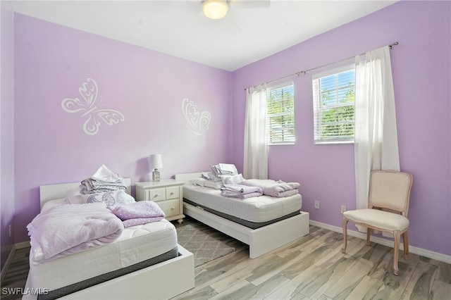 1000 L Ambiance Cir Unit 205, Naples, FL 34108 - bedroom with light wood-style flooring and a ceiling fan