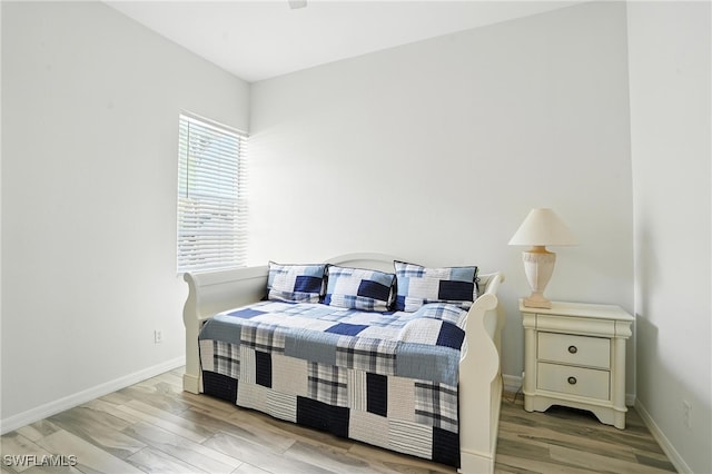 1000 L Ambiance Cir Unit 205, Naples, FL 34108 - bedroom featuring wood finished floors and baseboards