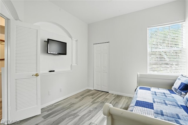 1000 L Ambiance Cir Unit 205, Naples, FL 34108 - bedroom with light wood-style flooring and a closet