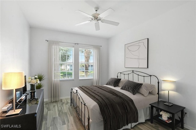 1000 L Ambiance Cir Unit 205, Naples, FL 34108 - bedroom with light wood-type flooring and ceiling fan