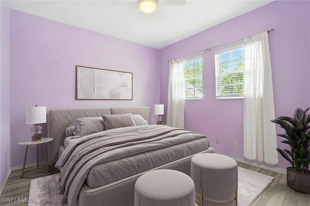 1000 L Ambiance Cir Unit 205, Naples, FL 34108 - bedroom with light wood-style floors and ceiling fan