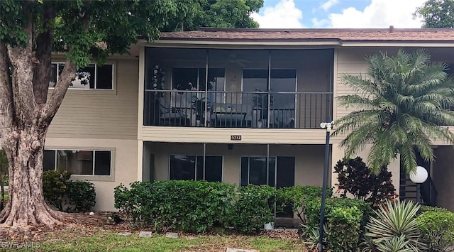 back of property featuring stucco siding