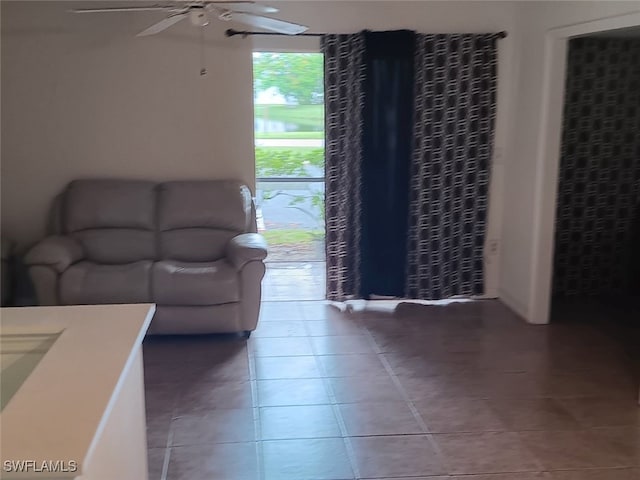 living room with ceiling fan and light tile patterned floors