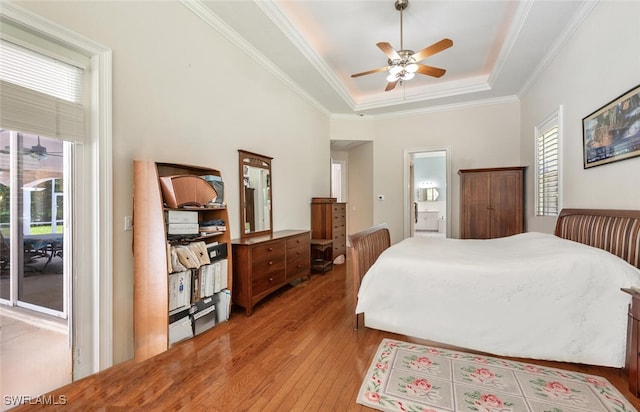 13915 Collier Blvd, Naples, FL 34119 - bedroom with light wood-style floors, a tray ceiling, multiple windows, access to outside, and crown molding
