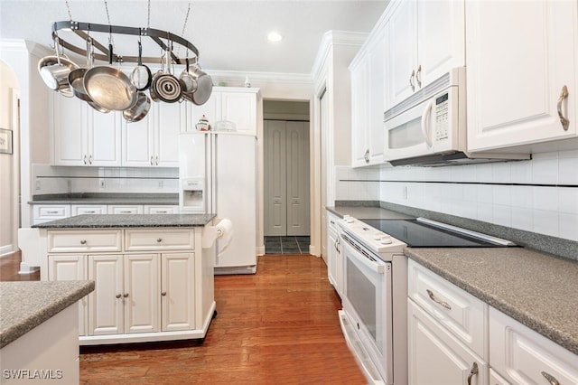 13915 Collier Blvd, Naples, FL 34119 - kitchen with white appliances, white cabinets, ornamental molding, decorative backsplash, and wood finished floors