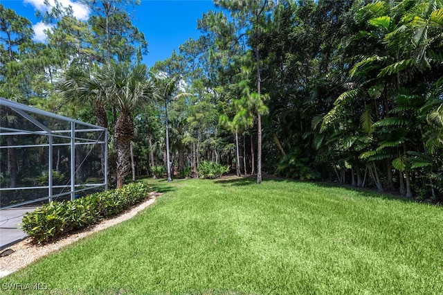 13915 Collier Blvd, Naples, FL 34119 - view of green lawn with a lanai