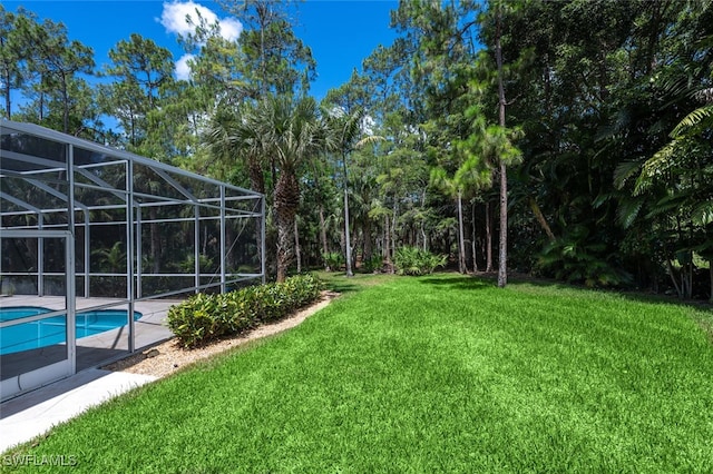 13915 Collier Blvd, Naples, FL 34119 - view of grassy yard with an outdoor pool and a lanai