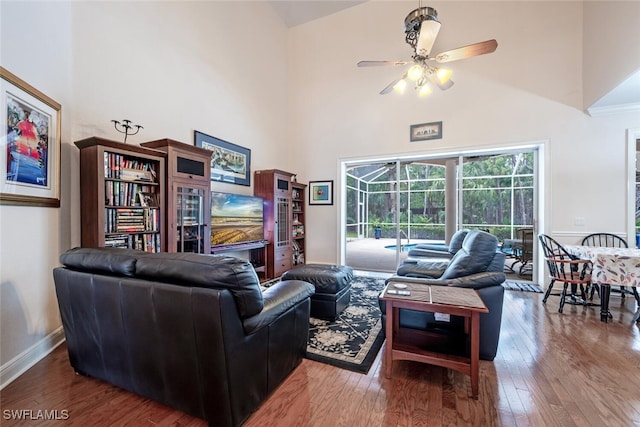 13915 Collier Blvd, Naples, FL 34119 - living room featuring high vaulted ceiling, ceiling fan, and wood-type flooring