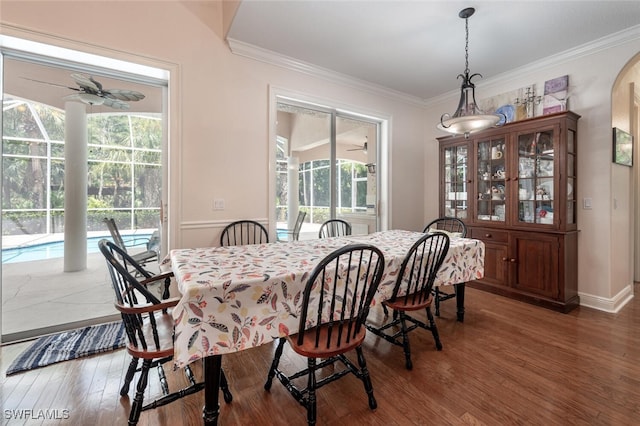 13915 Collier Blvd, Naples, FL 34119 - dining area with wood finished floors, healthy amount of natural light, crown molding, ceiling fan, and arched walkways