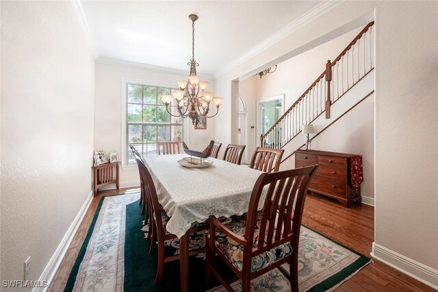 13915 Collier Blvd, Naples, FL 34119 - dining area with a chandelier, ornamental molding, wood finished floors, and stairs