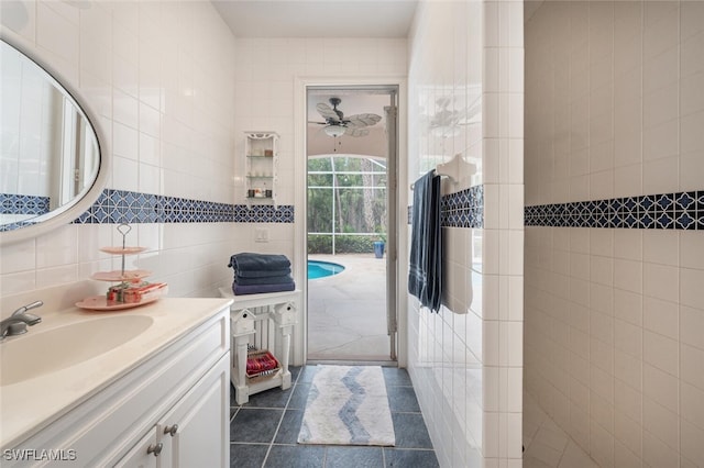 13915 Collier Blvd, Naples, FL 34119 - bathroom with tile walls, vanity, and tile patterned flooring