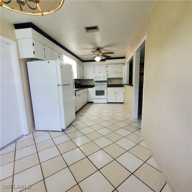 1101 E Jasmine Rd, Lehigh Acres, FL 33936 - kitchen with white appliances, a ceiling fan, dark countertops, and white cabinets