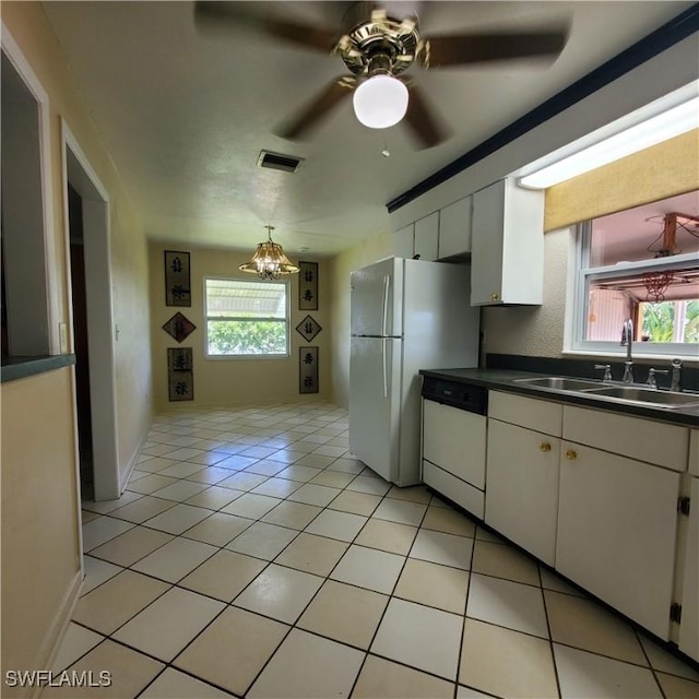 1101 E Jasmine Rd, Lehigh Acres, FL 33936 - kitchen featuring white appliances, white cabinetry, plenty of natural light, and dark countertops