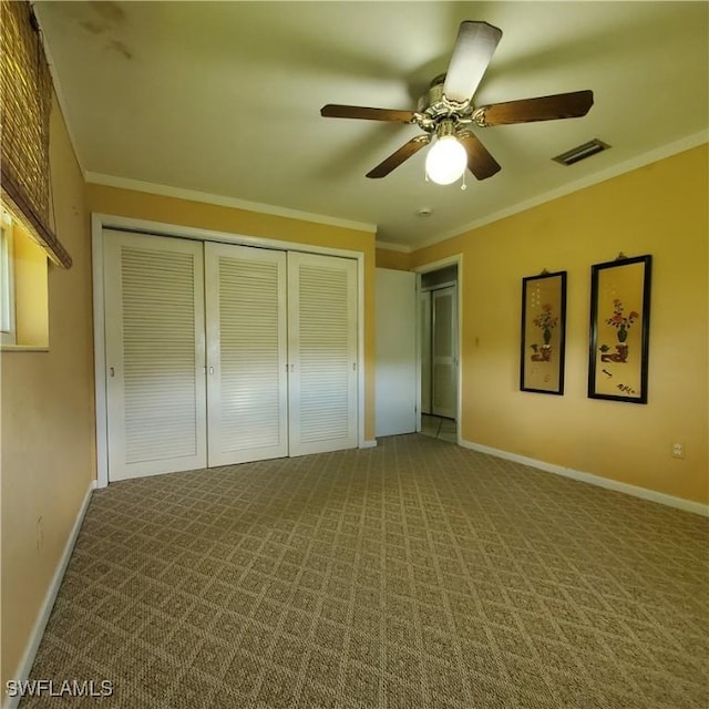 1101 E Jasmine Rd, Lehigh Acres, FL 33936 - unfurnished bedroom featuring a closet, carpet, crown molding, ceiling fan, and ensuite bath
