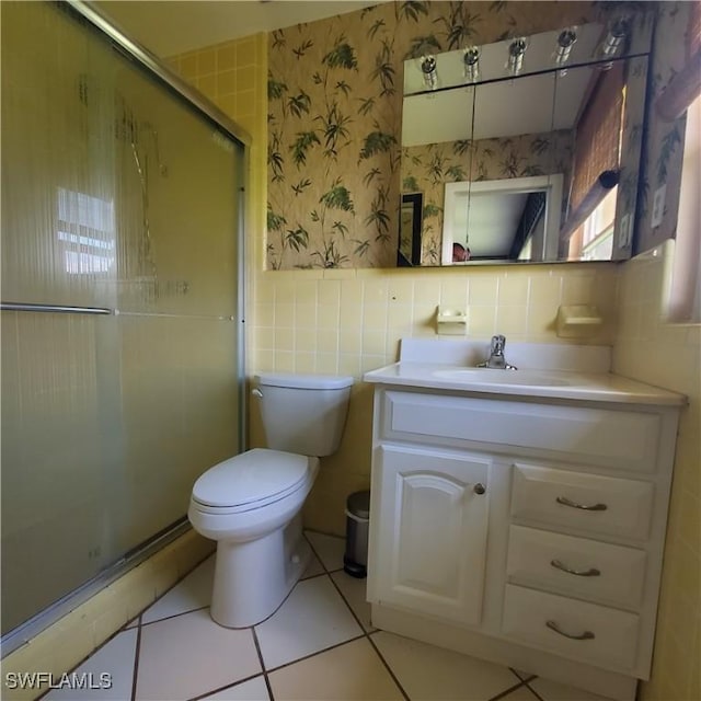 1101 E Jasmine Rd, Lehigh Acres, FL 33936 - full bath featuring tile walls, vanity, wallpapered walls, a stall shower, and tile patterned flooring