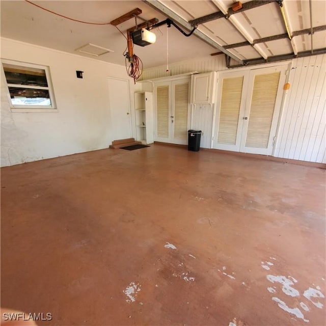1101 E Jasmine Rd, Lehigh Acres, FL 33936 - garage featuring french doors and a garage door opener