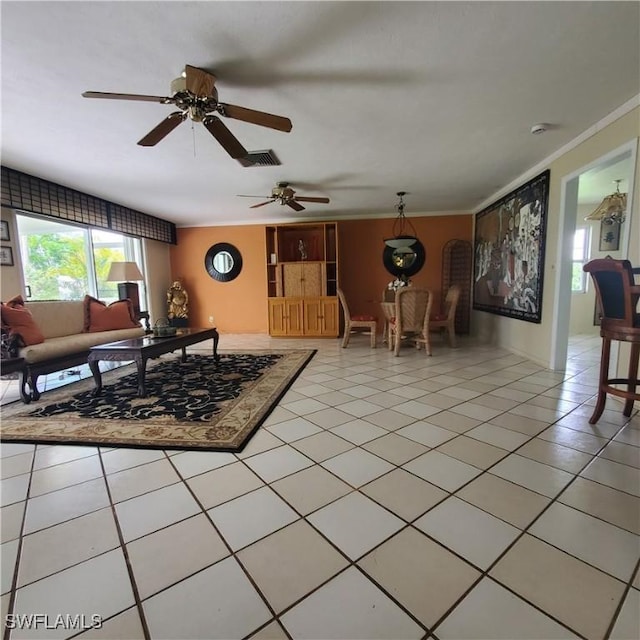 1101 E Jasmine Rd, Lehigh Acres, FL 33936 - living room featuring ornamental molding, a ceiling fan, and light tile patterned floors