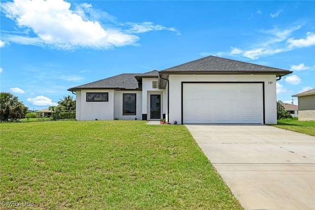 147 Partridge St, Lehigh Acres, FL 33974 - prairie-style house featuring stucco siding, concrete driveway, an attached garage, and a front lawn