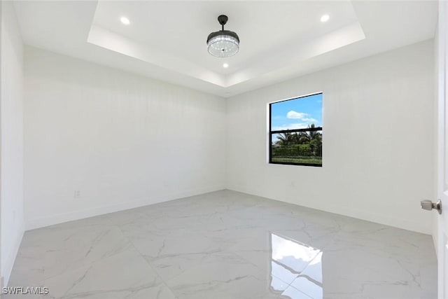 147 Partridge St, Lehigh Acres, FL 33974 - unfurnished room featuring marble finish flooring, recessed lighting, and a raised ceiling
