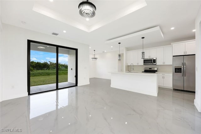 147 Partridge St, Lehigh Acres, FL 33974 - kitchen featuring appliances with stainless steel finishes, a tray ceiling, white cabinetry, light countertops, and recessed lighting